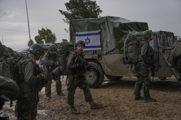 Israeli soldiers prepare to enter the Gaza Strip, at a staging area near the Israeli-Gaza border.