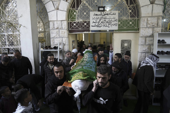 Mourners carry the body of Nassim Abu Fouda during his funeral in the West Bank city of Hebron. Israeli forces shot and killed the Palestinian man in the flashpoint city in the occupied West Bank on Monday, the Palestinian Health Ministry said. 