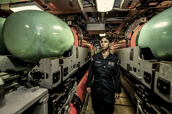 A US Navy officer next to MK-48 torpedoes aboard a Virginia class submarine on a port visit to Rockingham, WA, in February.   