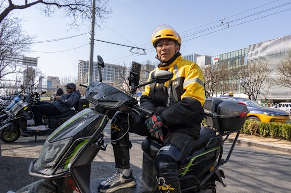 Ren Fei, 42, began working as a delivery driver for Meituan in Beijing a month ago. He says it is not easy work and many people quit after a few days.