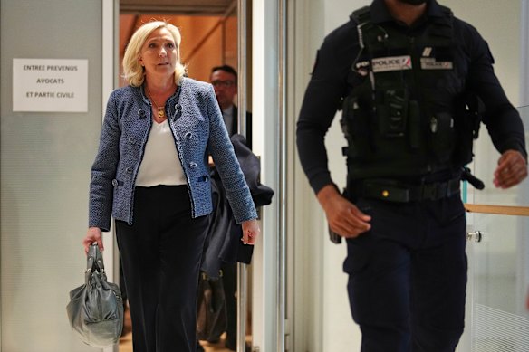 Marine Le Pen leaves the courtroom after a judge found her guilty in an embezzlement case.