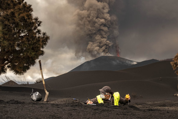 A scientist from IGME-CSIC (Spanish National Research Council) collects samples of volcanic ashes.