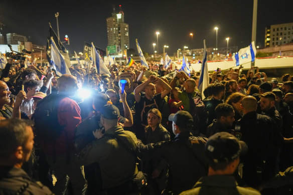 Police push people who take part in a protest against Israeli Prime Minister Benjamin Netanyahu’s government and call for the release of hostages held in the Gaza Strip by Hamas outside of the Knesset, Israel’s parliament, in Jerusalem. 