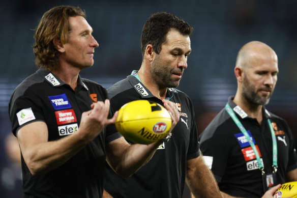 GWS assistant coaches James Hird and Dean Solomon speak with Giants interim coach Mark McVeigh.