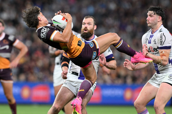 Reece Walsh in flight against the Melbourne Storm.