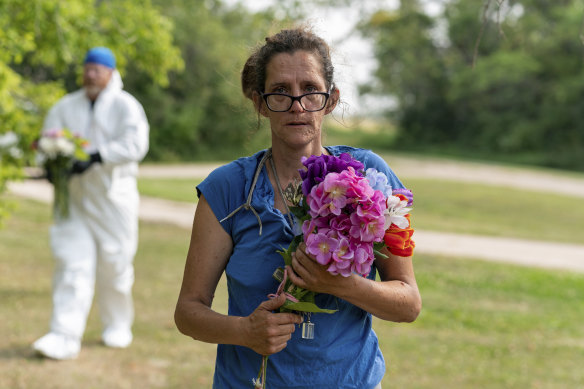 Ruby Works brings flowers to the home of a victim who has been identified by residents as Wes Petterson in Weldon, Saskatchewan.
