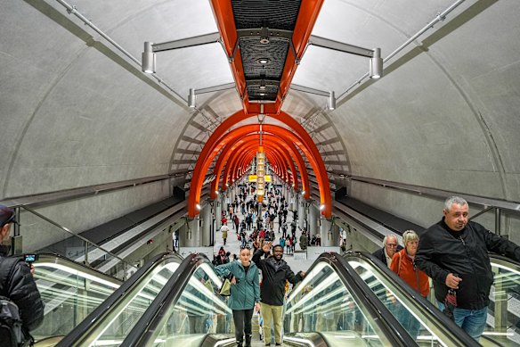 Commuters use the escalators from the platform to the concourse at Town Hall station.