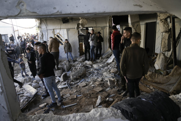 Palestinians look at the aftermath of an Israeli military raid on Jenin refugee camp.