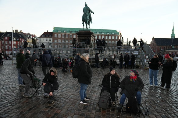 People arrive at Christiansborg Castle Square in Copenhagen.