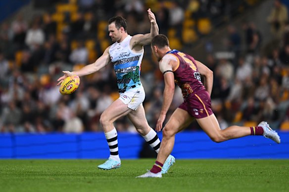 Patrick Dangerfield of the Cats competes against the Lions.