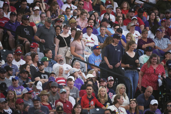 With COVID-19 restrictions lifted, fans watch a baseball game between the St. Louis Cardinals and the Colorado Rockies in Denver.