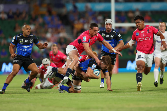 Tim Anstee of the Force gets tackled during the round 1 match against the Melbourne Rebels at HBF Park.