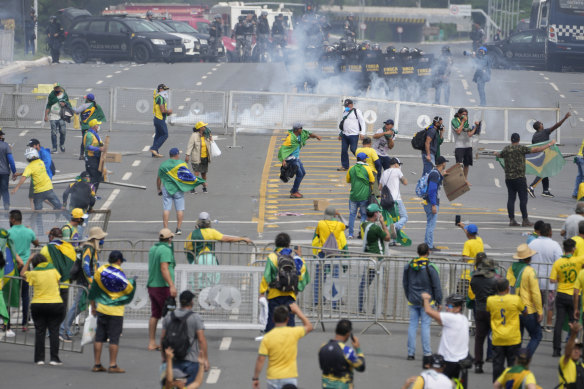 Protesters, supporters of Brazil’s former President Jair Bolsonaro, clash with police as they storm the Planalto Palace in Brasilia.