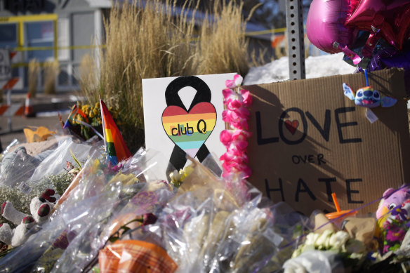 Bouquets of flowers sit on a corner near the site of a mass shooting at a gay bar in Colorado Springs, Colorado.