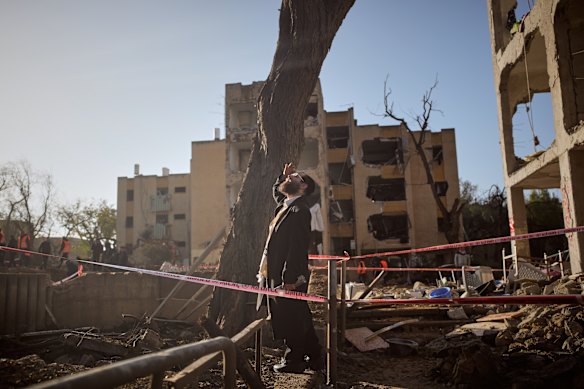 A man surveys the damage in Arad on Sunday.