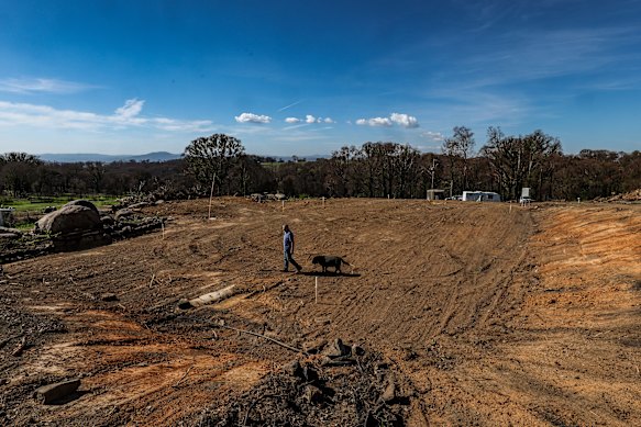 Rio Crupi with his dog Angus on the spot where his house stood. 