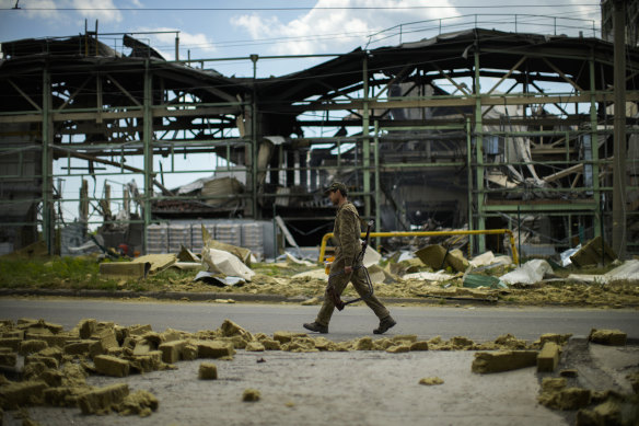A Ukrainian serviceman outside a manufacturing plant destroyed in a Russian bombing in Bakhmut, eastern Ukraine in late May. 