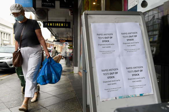 A sign notifying customers of no Rapid Antigen Tests (RAT) in stock is placed outside a chemist.