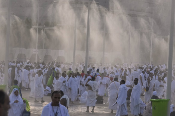 Water is sprayed on Muslim pilgrims at the rocky hill known as the Mountain of Mercy.