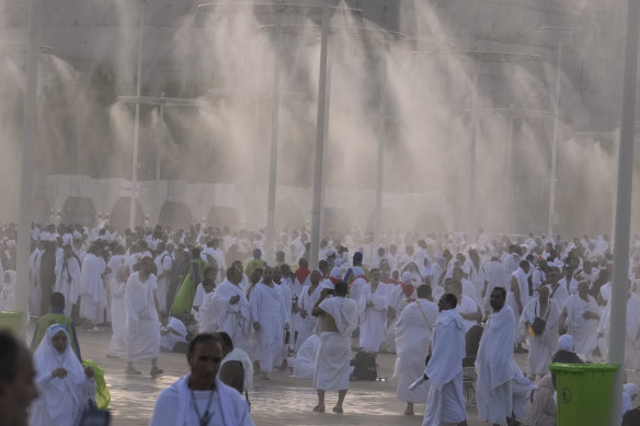 Water is sprayed on Muslim pilgrims at the rocky hill known as the Mountain of Mercy.