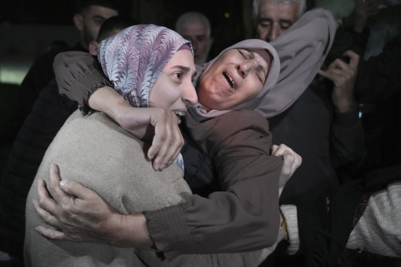 Shuruq Dwayat (left), a Palestinian priso<em></em>ner released by Israel, is hugged by relatives as she arrives home in the east Jerusalem neighbourhood of Sur Bahar early on Sunday.