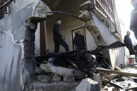 A Palestinian cleans up the damage after an Israeli military raid on the town of Tubas in the West Bank on Sunday,