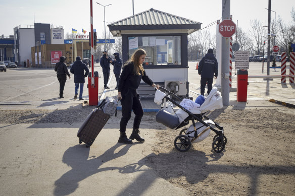 A refugee who fled the conflict in Ukraine crosses the border at Palanca, Moldova on Saturday.