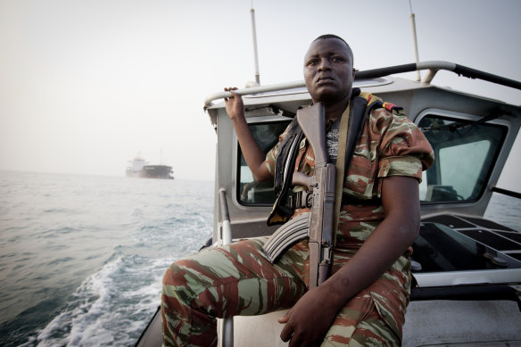 A member of an anti-piracy team from Benin, in West Africa, on patrol in the Bight of Benin in 2011.  
