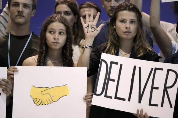 Climate activists from Germany encourage world leaders to maintain policies that limit warming to 1.5 degrees at the COP27 UN Climate Summit on Saturday.