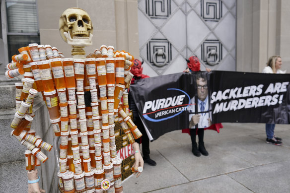 “Pill Man” made by Frank Huntley from his opioid prescription pill bottles, joins a protest by advocates for opioid victims outside the US Department of Justice in December.