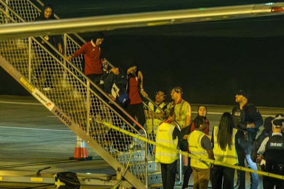 The Iranian women’s soccer team is taken from plane to a bus at Sydney Airport on Tuesday night. 