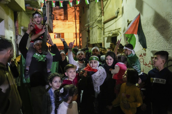 Aseel al-Titi, wearing a Hamas headband, a former Palestinian prisoner who was released by the Israeli authorities, is greeted by friends and family members in Balata.