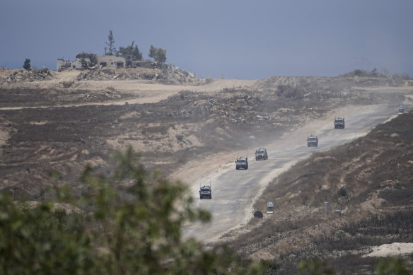 A column of Israeli military vehicles leave the Gaza Strip, as seen from southern Israel.