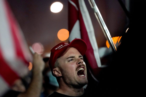 Supporters of President Donald Trump rally outside the Maricopa County Recorders Office.