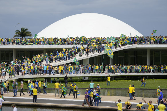 Protesters, supporters of Brazil’s former president Jair Bolsonaro, storm the Congress building in Brasilia on January 8, 2023, a week after his successor Luis Inacio Lula da Silva, took office.