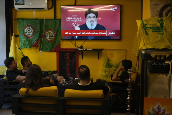 People in a Beirut cafe watch the speech of Hezbollah leader Hassan Nasrallah.