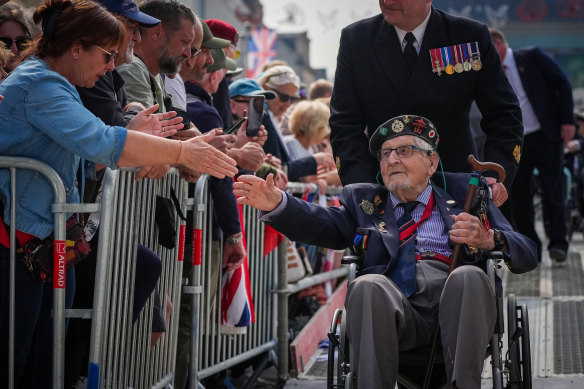 D-Day veterans are applauded by the crowd after a parade with a Royal Guard Of Honour in Arromanches-les-Bains, France.