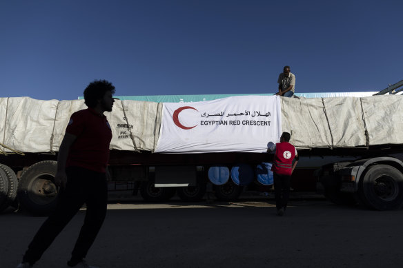 An Egyptian Red Crescent member prepares an aid convoy truck to cross the Rafah border from the Egyptian side on October 21.
