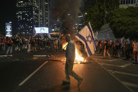 Israelis light a bonfire during a protest after Yoav Gallant was sacked as defence minister.