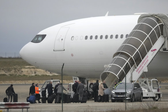 Crew members board the plane grounded by police at the Vatry airport.