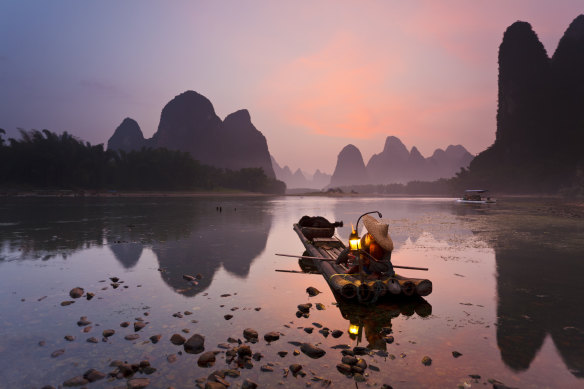 Cormorant fisherman getting ready for work on the Li River, near Xingping Town, Guangxi province.