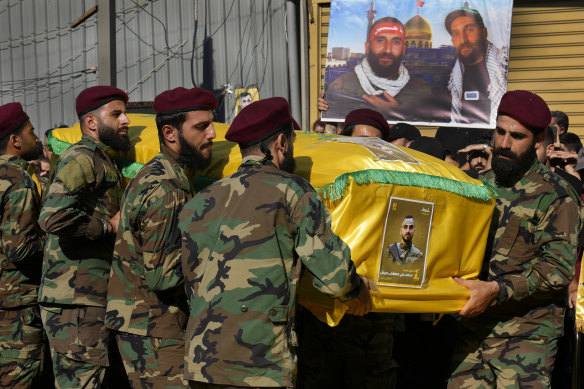 Hezbollah fighters carry the coffin of their comrade who was killed with three others on Saturday by an Israeli airstrike in south Lebanon.