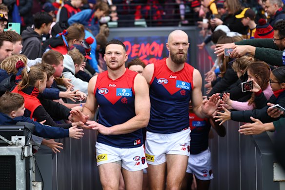 Steven May and Max Gawn lead the Demons players out.