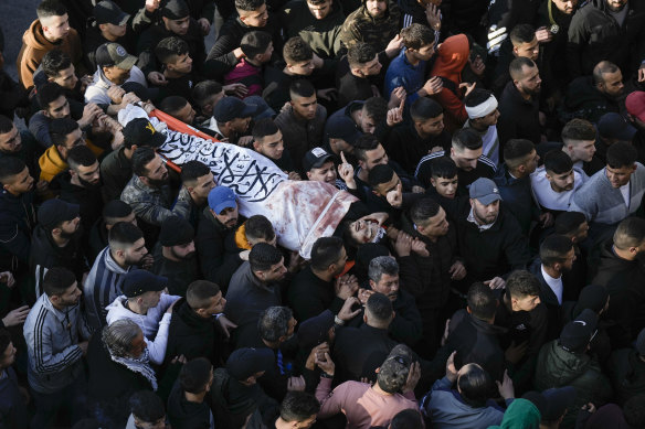 Palestinians carry the body of man who was killed in the clashes.