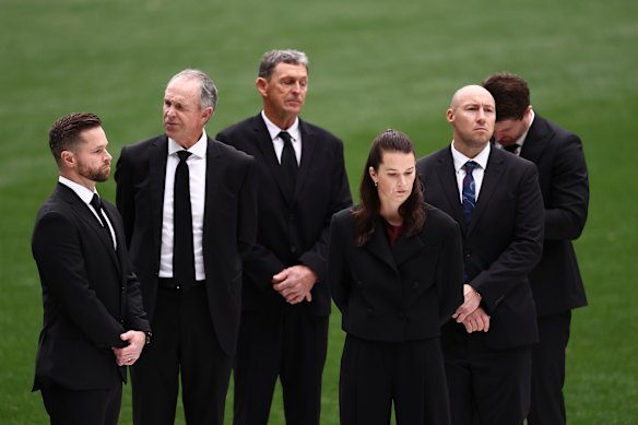 Members of the Daniher family on the MCG as the service draws towards a close.