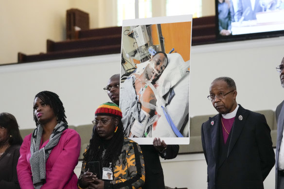 Family members and supporters hold a photograph of Tyre Nichols at a news conference.