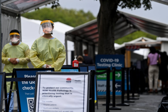 Healthcare workers dressed in PPE are seen at the Royal Prince Alfred Hospital COVID-19 clinic in Sydney on Sunday.