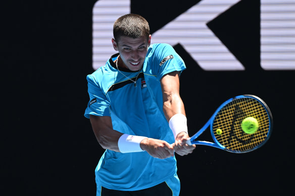 Alexei Popyrin plays a backhand in his round one singles match against fellow Aussie Marc Polmans.