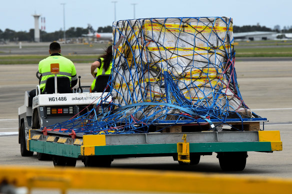 The first Australian shipment of Pfizer COVID-19 vaccines is seen being transported off the tarmac after landing at Sydney Airport on Monday.