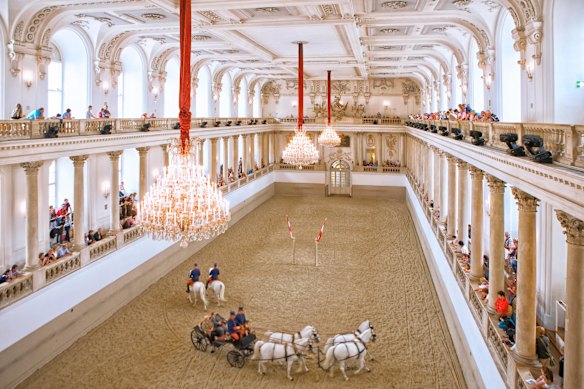 Horses parade at the Spanish Riding School of Vienna.